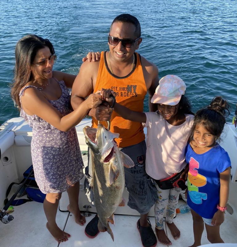 family catching lake trout on our fishing charter