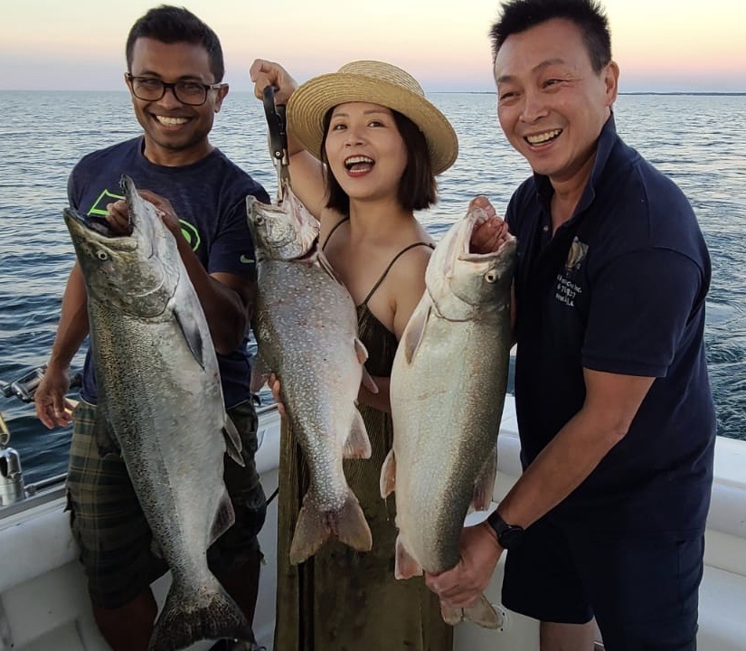 friends catch trout and salmon on charter